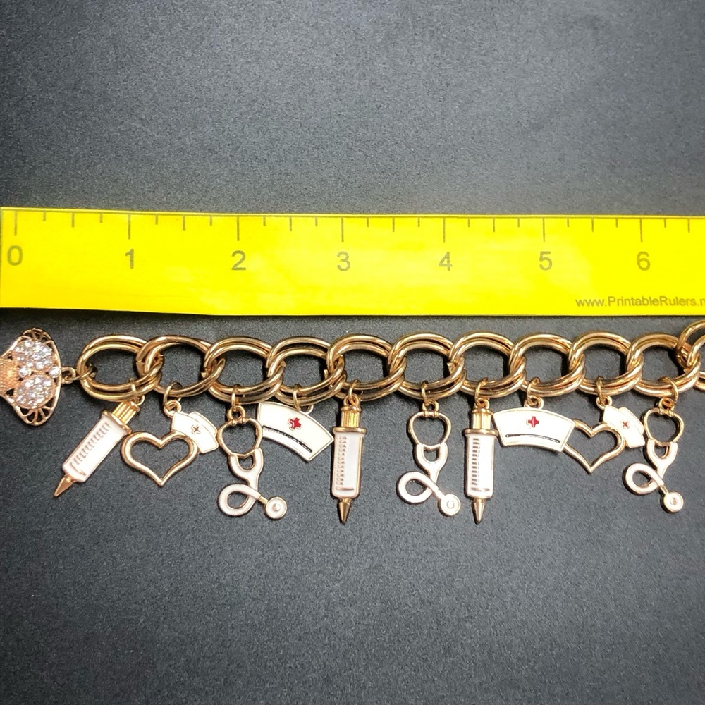 Gold and White Charm Bracelet with Unique Designs